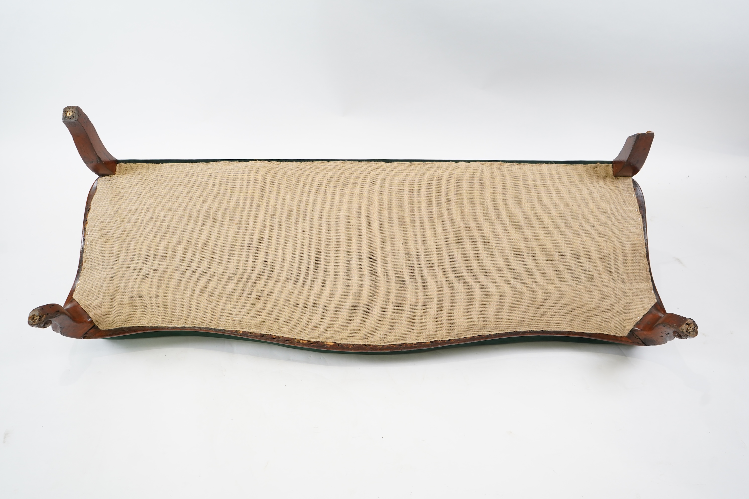 A pair of Victorian carved oak settees, recently re-upholstered in deep buttoned green velvet, the scroll carved crest rails over serpentine seats on cabriole front legs, 160cm wide, 96cm high, Provenance - previously gi